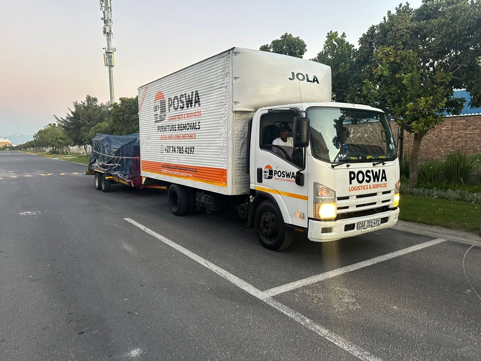 Poswa truck towing a covered load