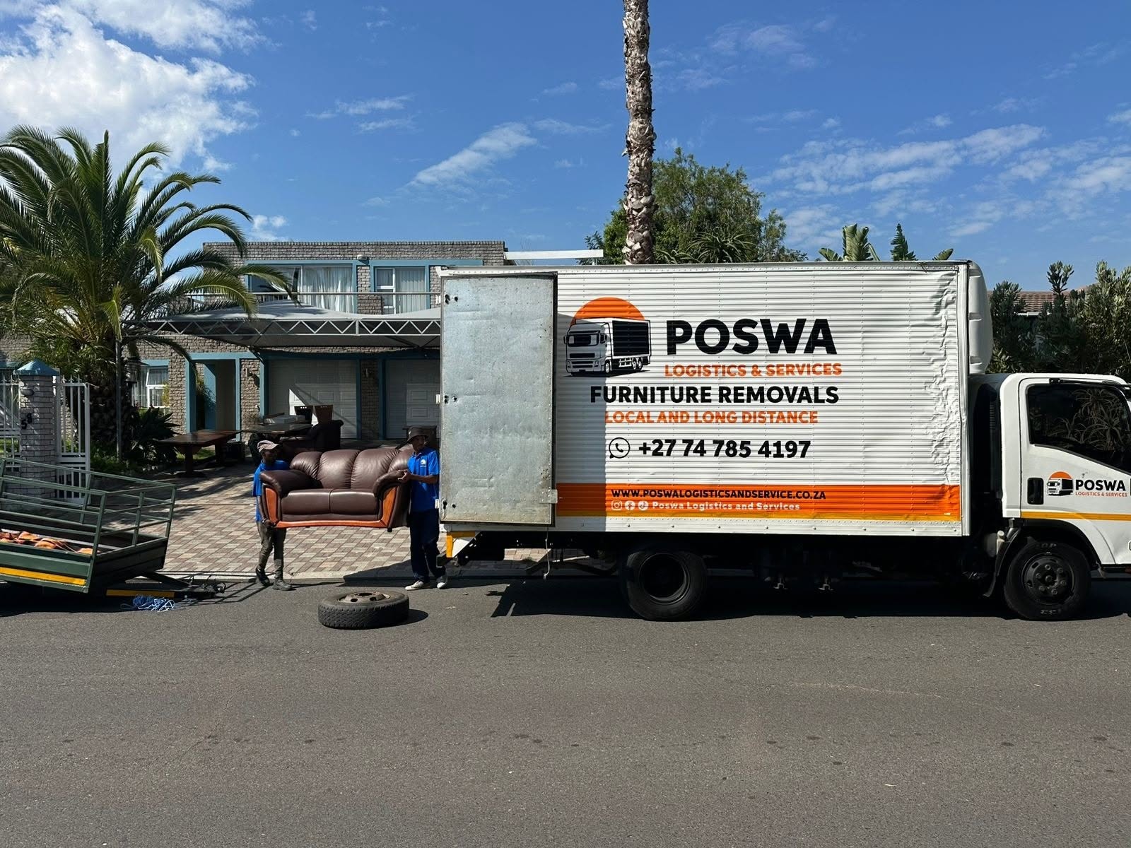 Poswa movers carrying a couch to the truck